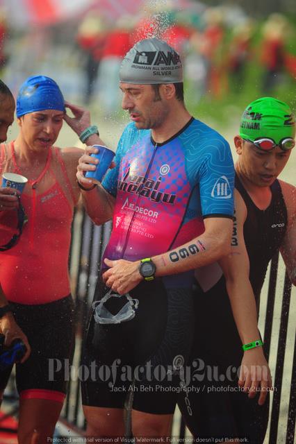 triathlete looking in drink cup after swim