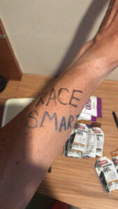 race smart written on arm in marker